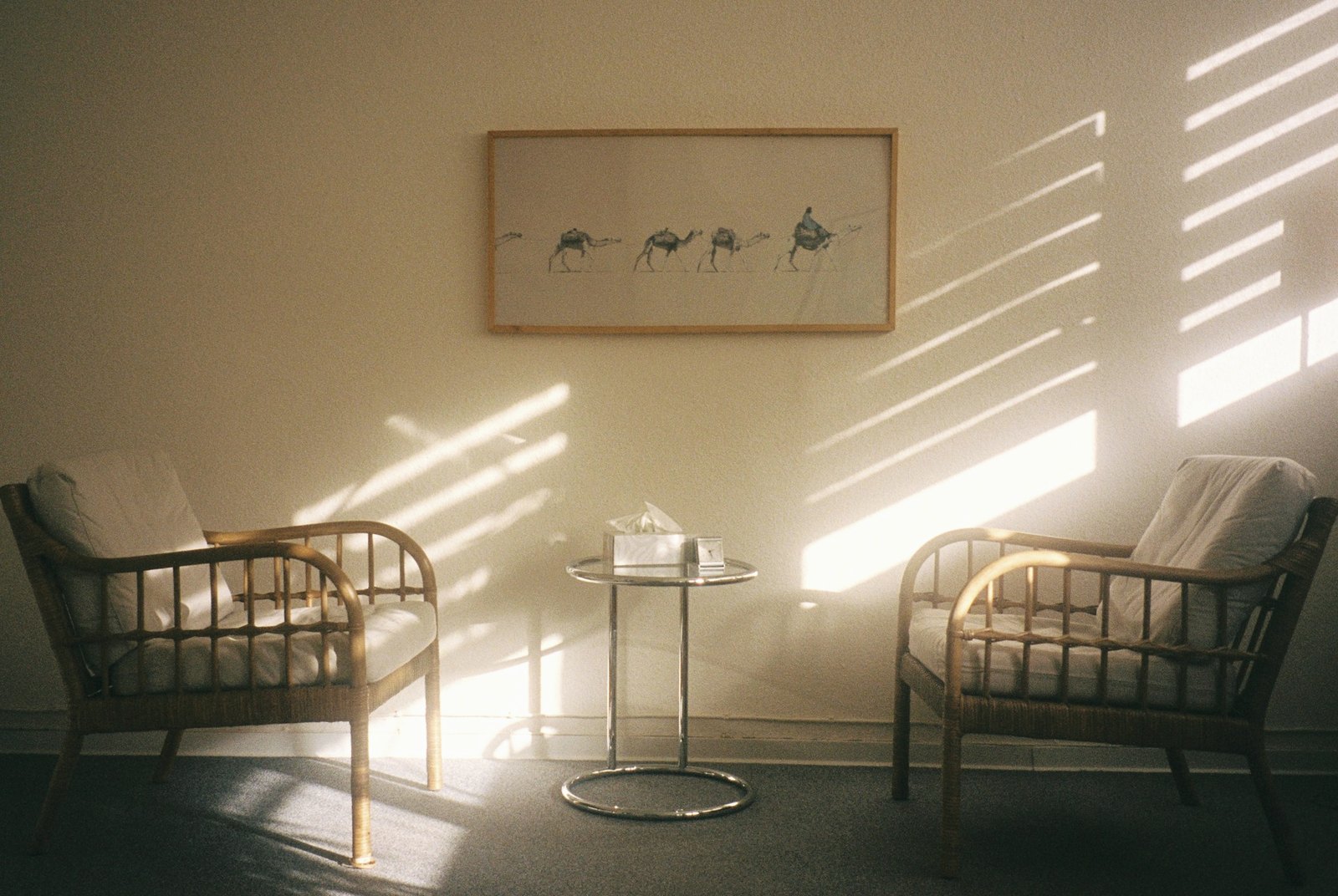 Two armchairs side by side next to a window, illustrative image